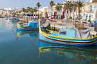 Malta, Marsaxlokk. Marsaxlokk harbor. Luzzijiet, colorful traditional Maltese fishing boats. Art Print